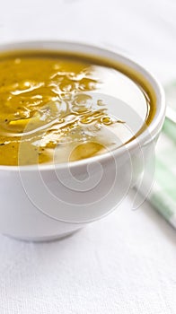 Close of white bowl with cabotia pumpkin soup