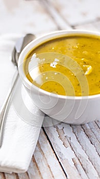 Close of white bowl with cabotia pumpkin soup