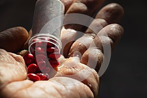 Close â€“ up medicine on hand.A man holding red medicine.