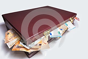 Closed 24 hour briefcase with euro banknotes coming out