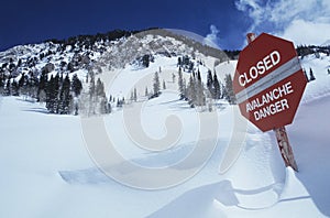 Closed--avalanche danger' sign in snow