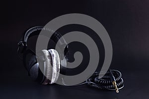 Closed-back studio headphones with a twisted cable