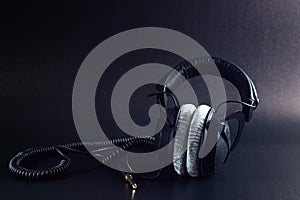 Closed-back studio headphones with a twisted cable