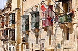 Closed balconies in the streets of Valletta , Malta