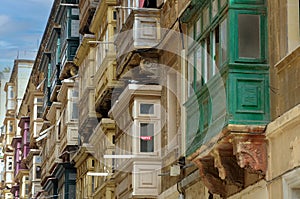 Closed balconies in the streets of Valletta , Malta