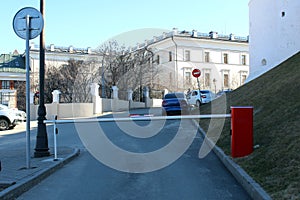 Closed barrier in a paid parking lot, warm sunny day