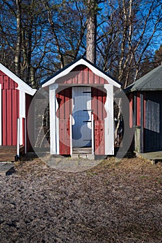 Closed beach hut decorated in red and white wood on the beach in Ystad Sweden during winter