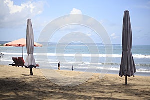 Closed Beach Umbrellas in Kuta Beach Bali Island, Indonesia photo