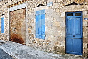 Closed blue shutters and door