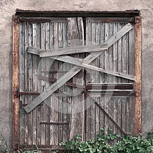 Closed, boarded-up old wooden door. Old abandoned house.