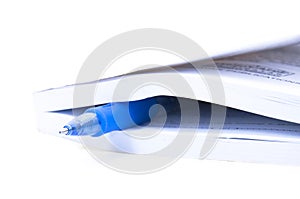 Closed Book And Blue pen Over White background