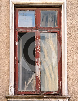 Closed broken wooden window of an old building