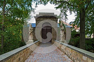 Closed castle door with statues on each side