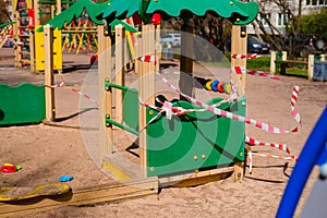 Closed children`s playground. COVID-19 security and protection measures in the city par