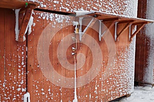 Closed Christmas market at winter snowy day. Wooden stalls with locks covered with snow.