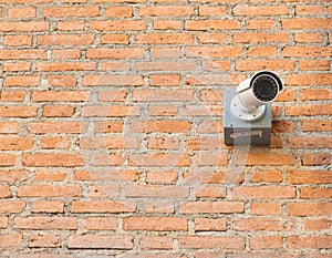 Closed circuit camera on brick wall