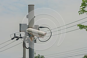 Closed-circuit camera on electric pole and walkway.