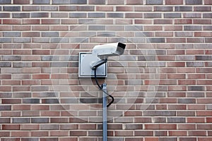 closed circuit camera mounted on a brick wall