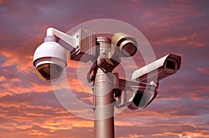 Closed circuit camera Multi-angle CCTV system. against a red sky