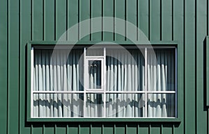 Closed curtains behind rectangular windows