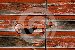 Closed door of an old red barn