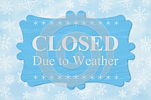 Closed Due to Weather message on a wood sign photo