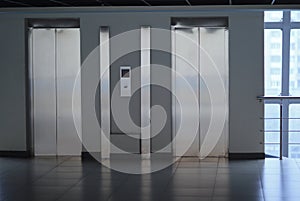 Closed Elevator doors and control panel in a modern office building