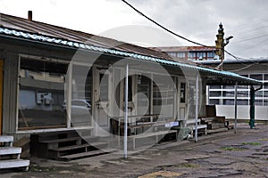 Closed, empty and aged market stands and stalls. Destroyed and broken asphalt on the market at the end of the day