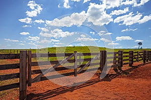 closed farm gate under blue sky with clouds