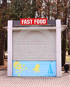 Closed fast food booth with jolly roger sign