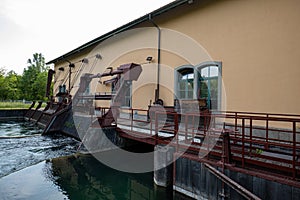 Closed floodgates of a small hydro electric plant in Switzerland, Europe. River water flowing through sieve gates, daytime, no