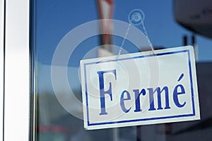 Closed french text means ferme on door boutique text sign board on windows shop restaurant cafe store signboard