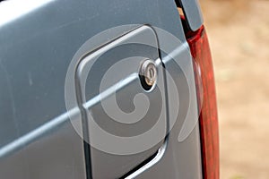 Closed Fuel tank of a car with old locking system and a side view of brake lights