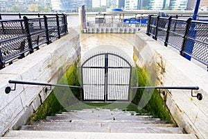 Closed gate on the riverside and stairs