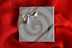Silver gift box with a bow