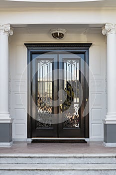 Closed Glossy Black and Glass Front Doors of an Upscale Home