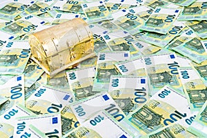 Closed golden treasure chest on euro money bills, Pandora chest concept of financial hazards