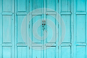 Closed green or blue wooden door. Vintage front door abstract background. Abandoned old house. Old wooden door texture