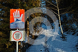 Closed hiking trail warning sign to STOP because of avalanches