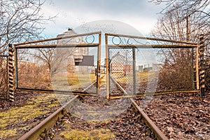 Closed  iron gates and old railway rails for trains