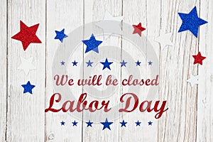 Closed Labor Day with red, white and blue stars on a weathered whitewash