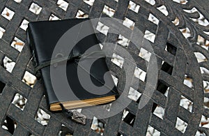 Closed leather bound journal on table outdoors