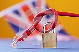 A closed lock on a tied network wire against the background of the British flag
