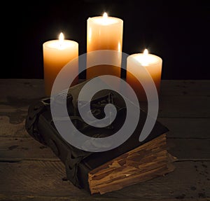 Closed magic book with candles