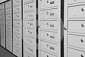 Closed metal mailboxes with keyholes and sequence numbers indoors