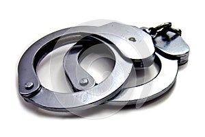 Closed metal police handcuffs on a white background isolated