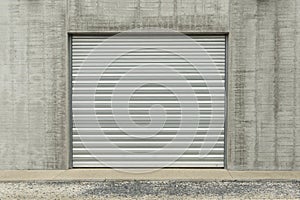 Metallic garage door in a grey industial wall photo