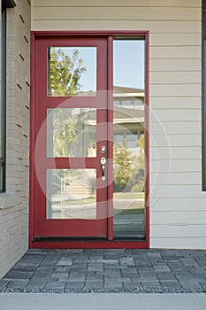 Closed modern red exterior door of a home