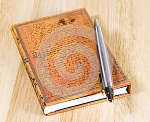 Closed notebook with pen