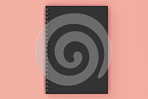 Closed notebook spiral bound on red background
